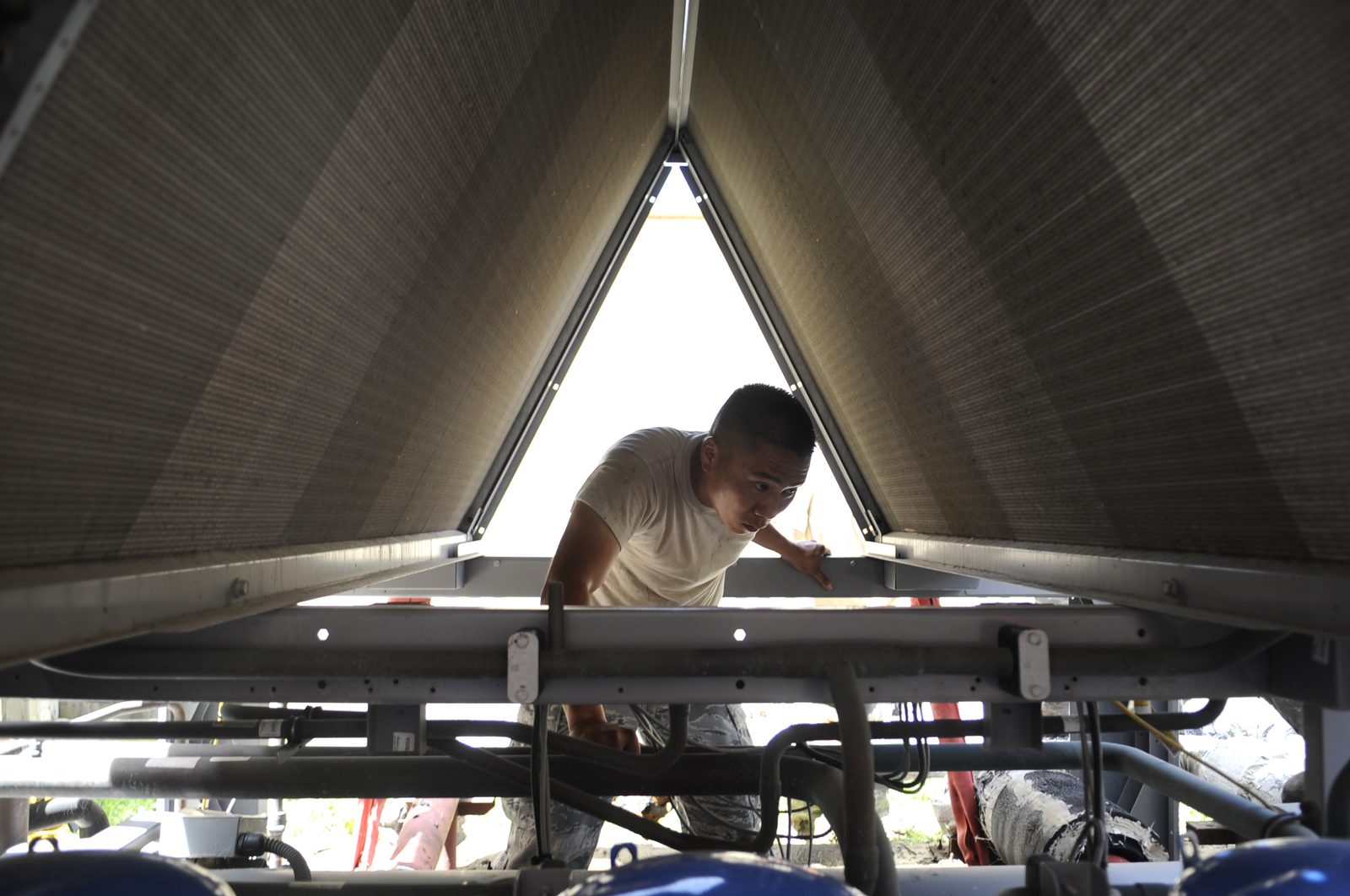 Installer working on equipment in an attic