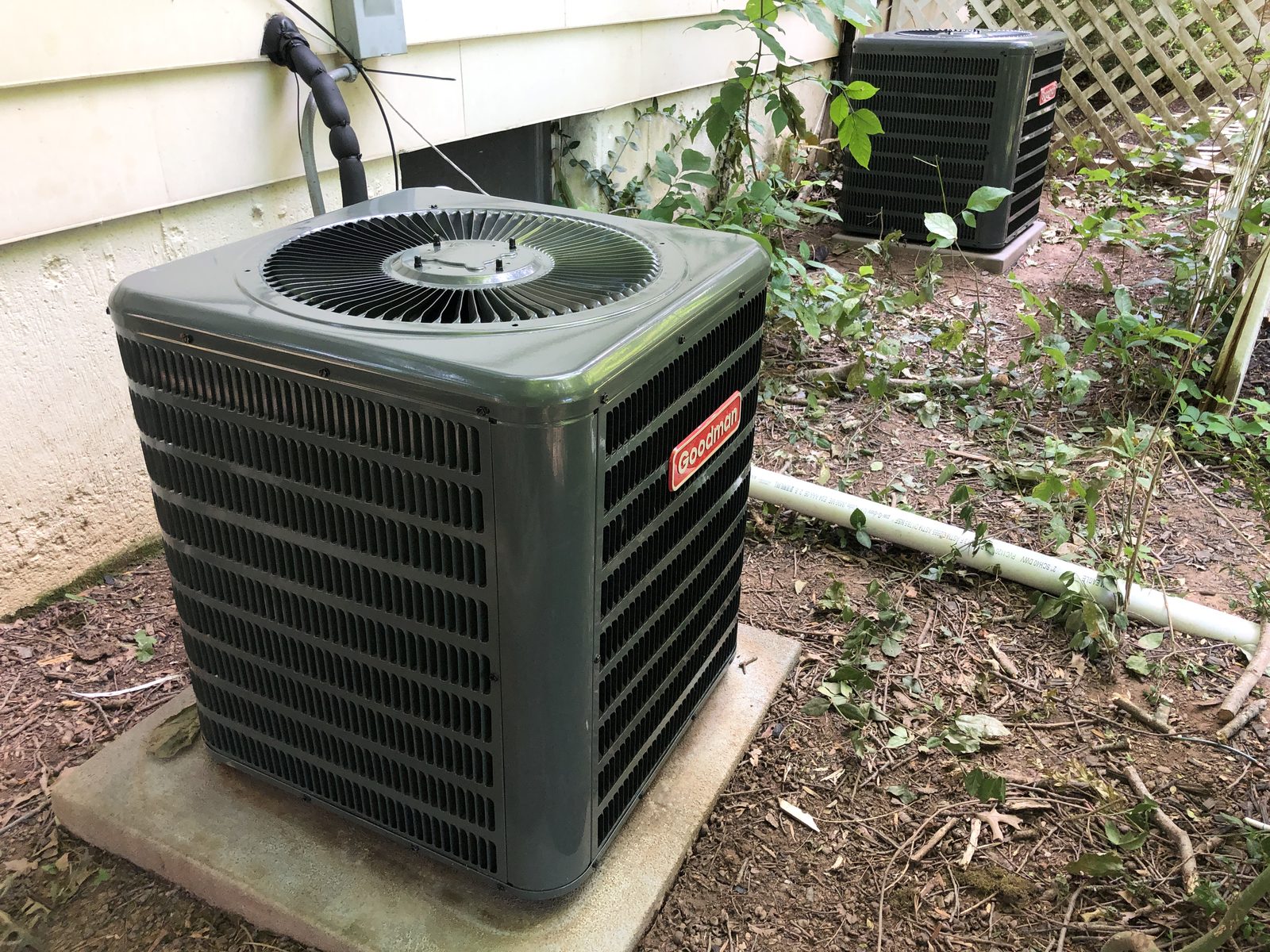 Outdoor condensing unit installed at the side of a house
