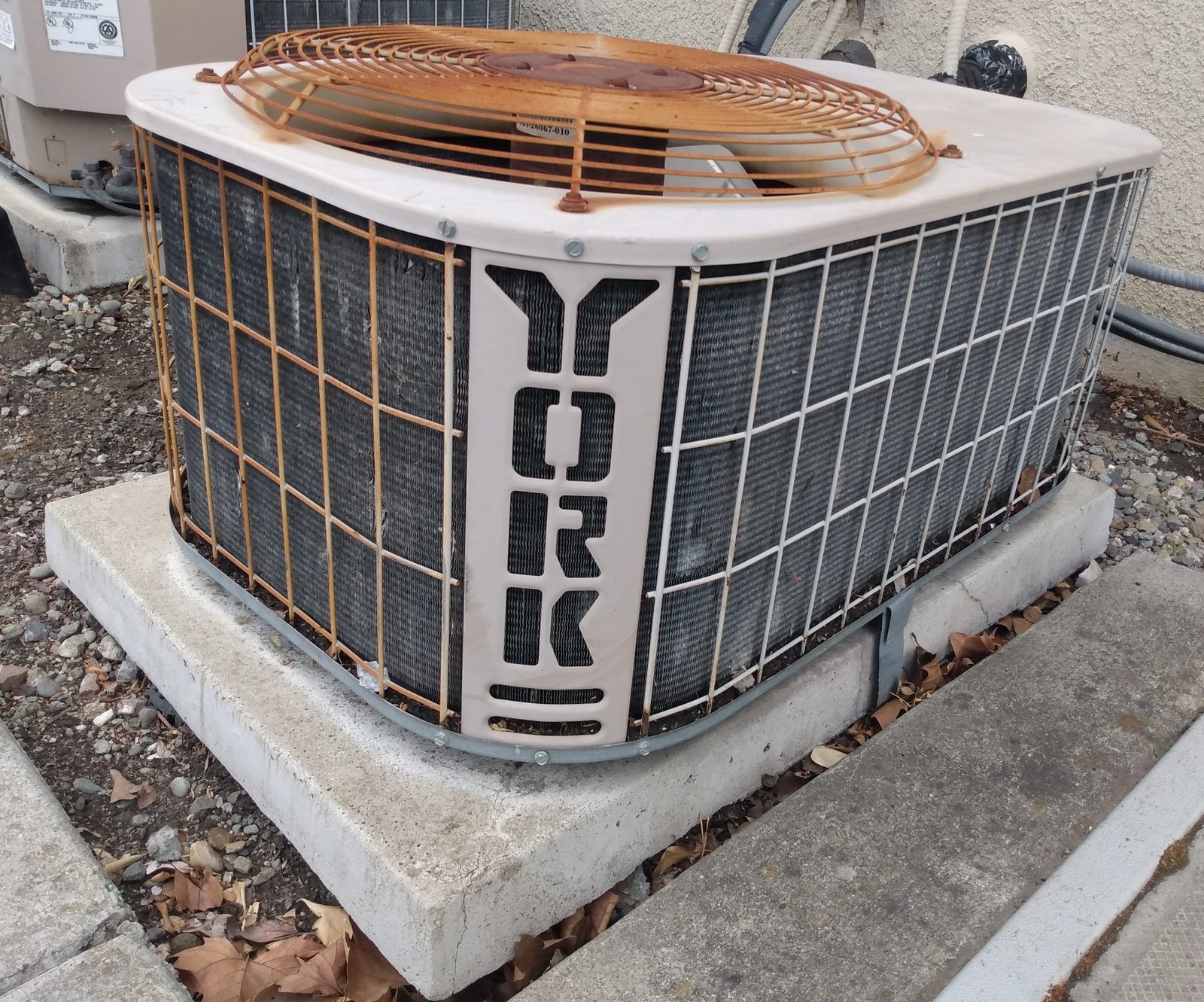 Outdoor air conditioning condenser on a concrete pad